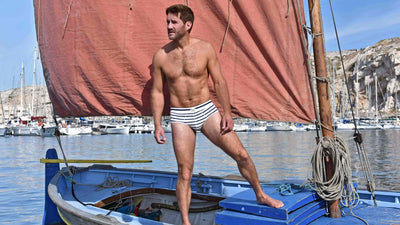 Bluebuck model wearing nautical brief on a boat in the sea